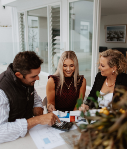 2 property buyers on the sunshine coast sitting around a table